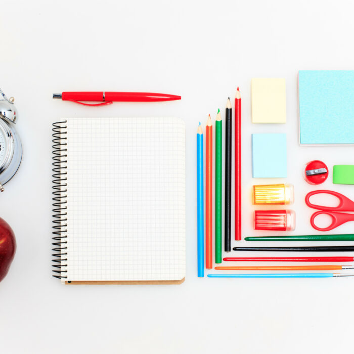 School set with back to school inscription, notebooks, pencils, brush, scissors and apple on white background